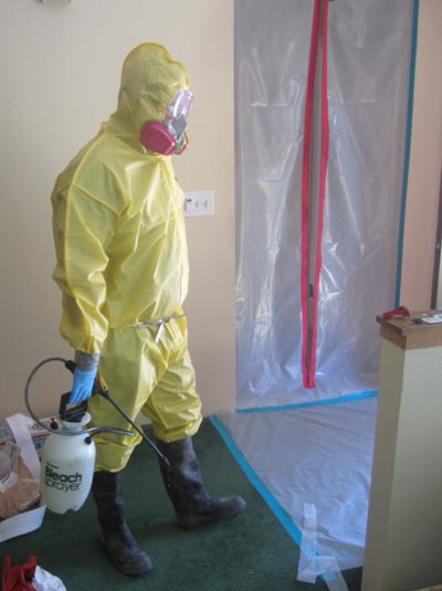 team member wearing ppe to clean biohazard